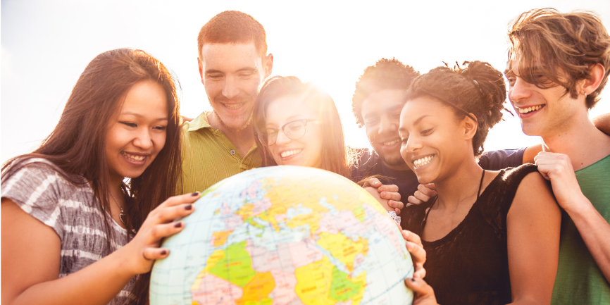 International students looking at a globe