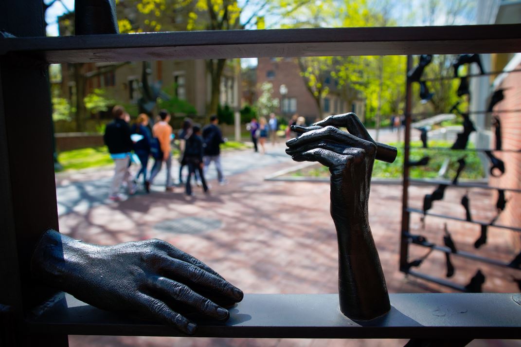 Sculpture of a hand holding a pencil